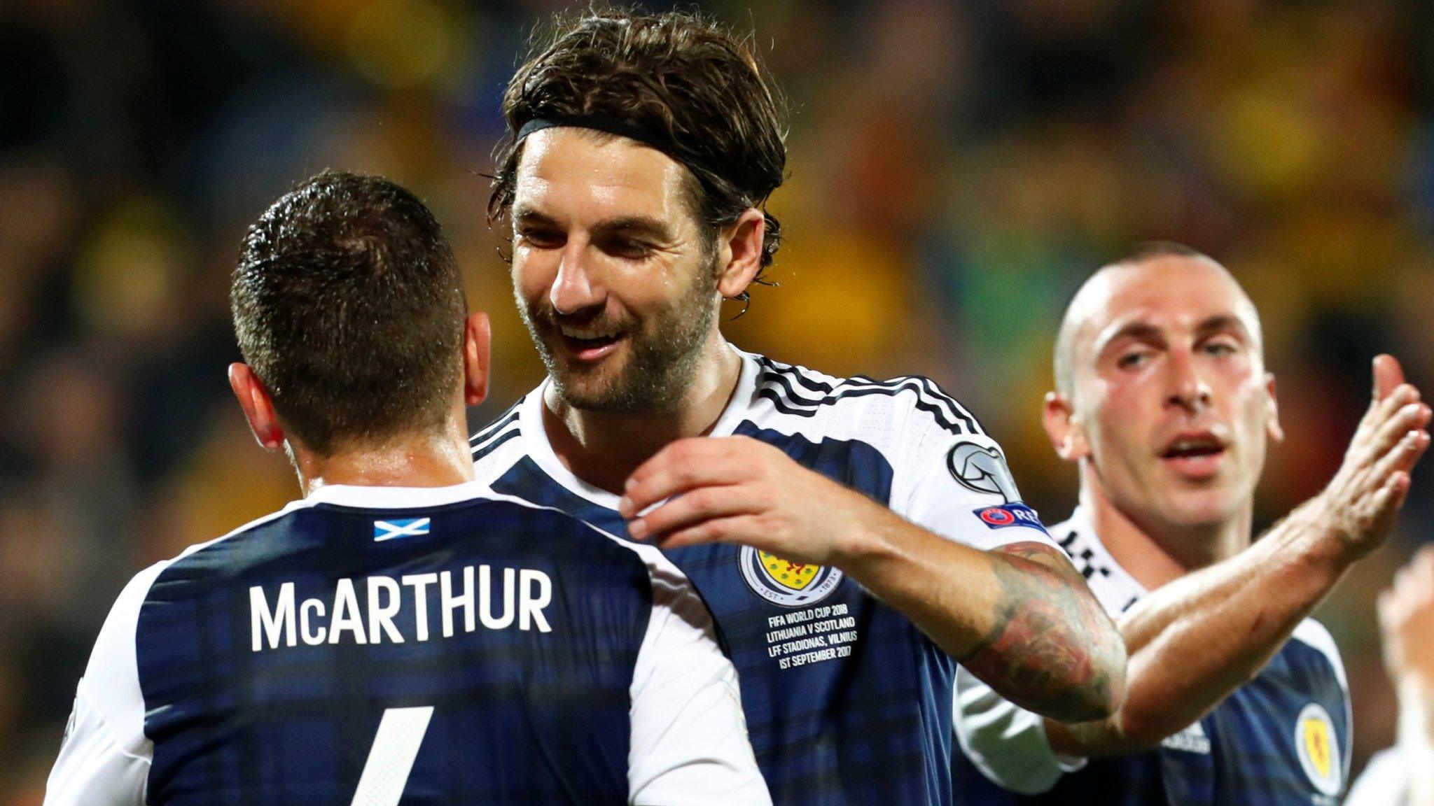 James McArthur and Charlie Mulgrew celebrate as Scotland beat Lithuania