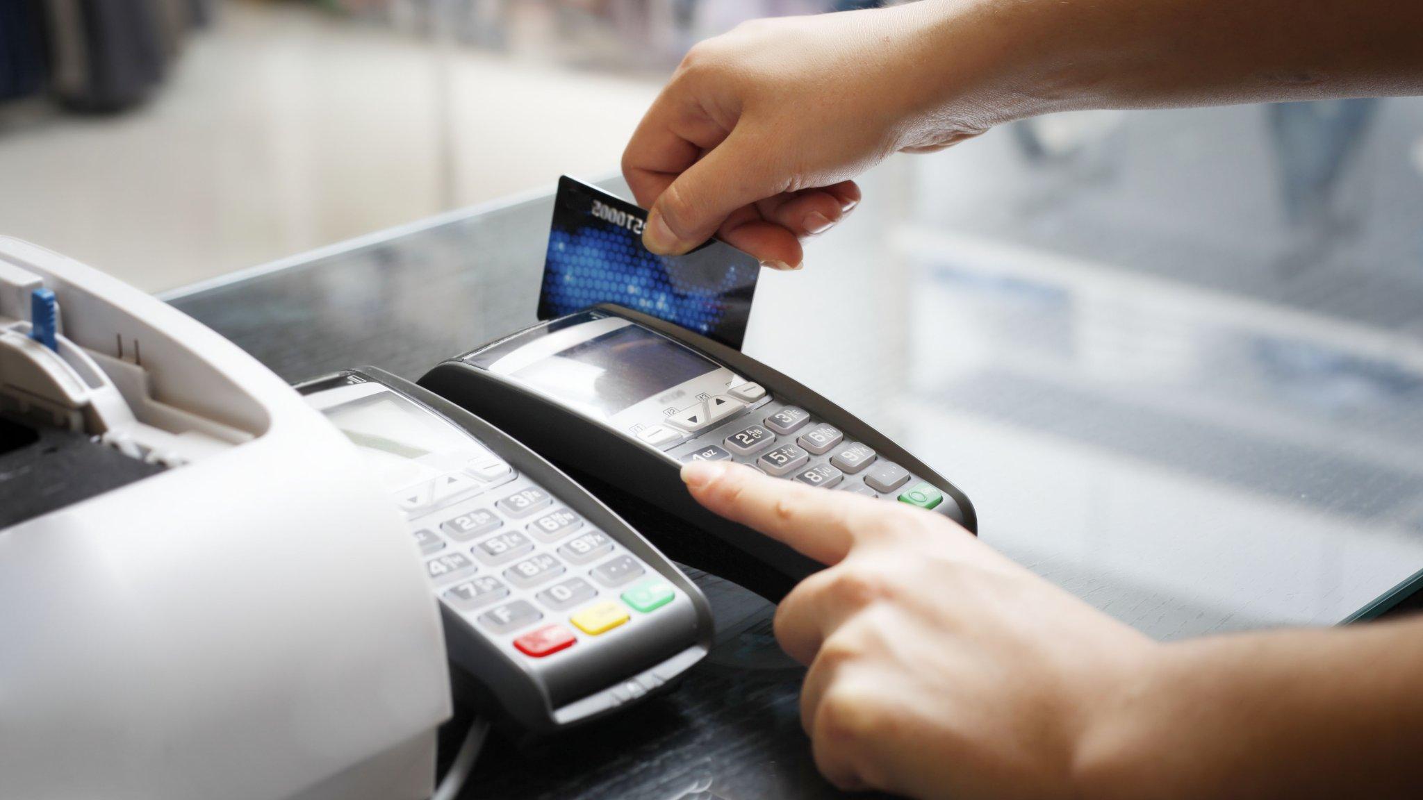 Credit card being swiped in a payment machine