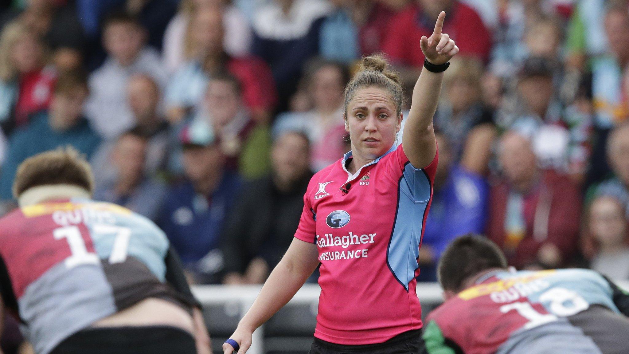 Sara Cox raises her hand to signal a refereeing decision