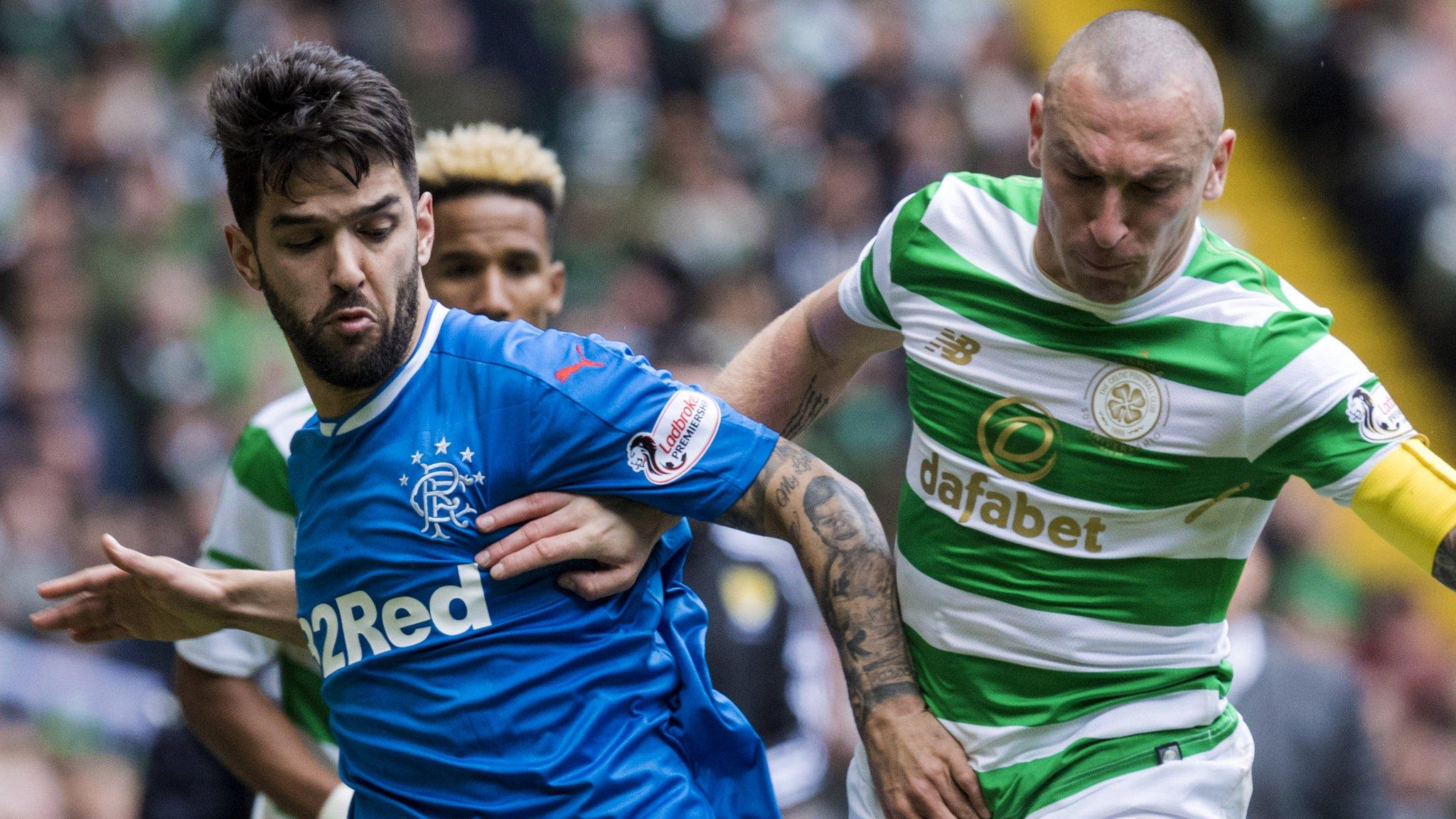 Daniel Candeias of Rangers and Celtic captain Scott Brown vie for posseesion