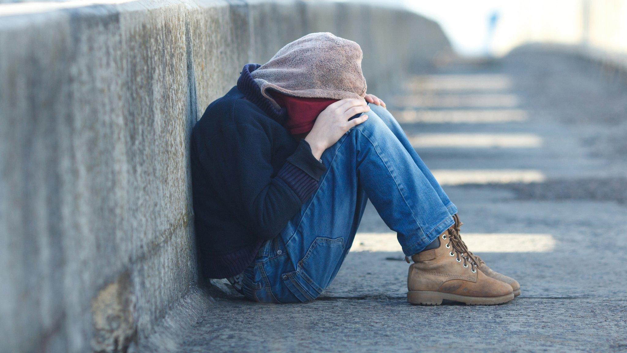 Boy sitting on streets