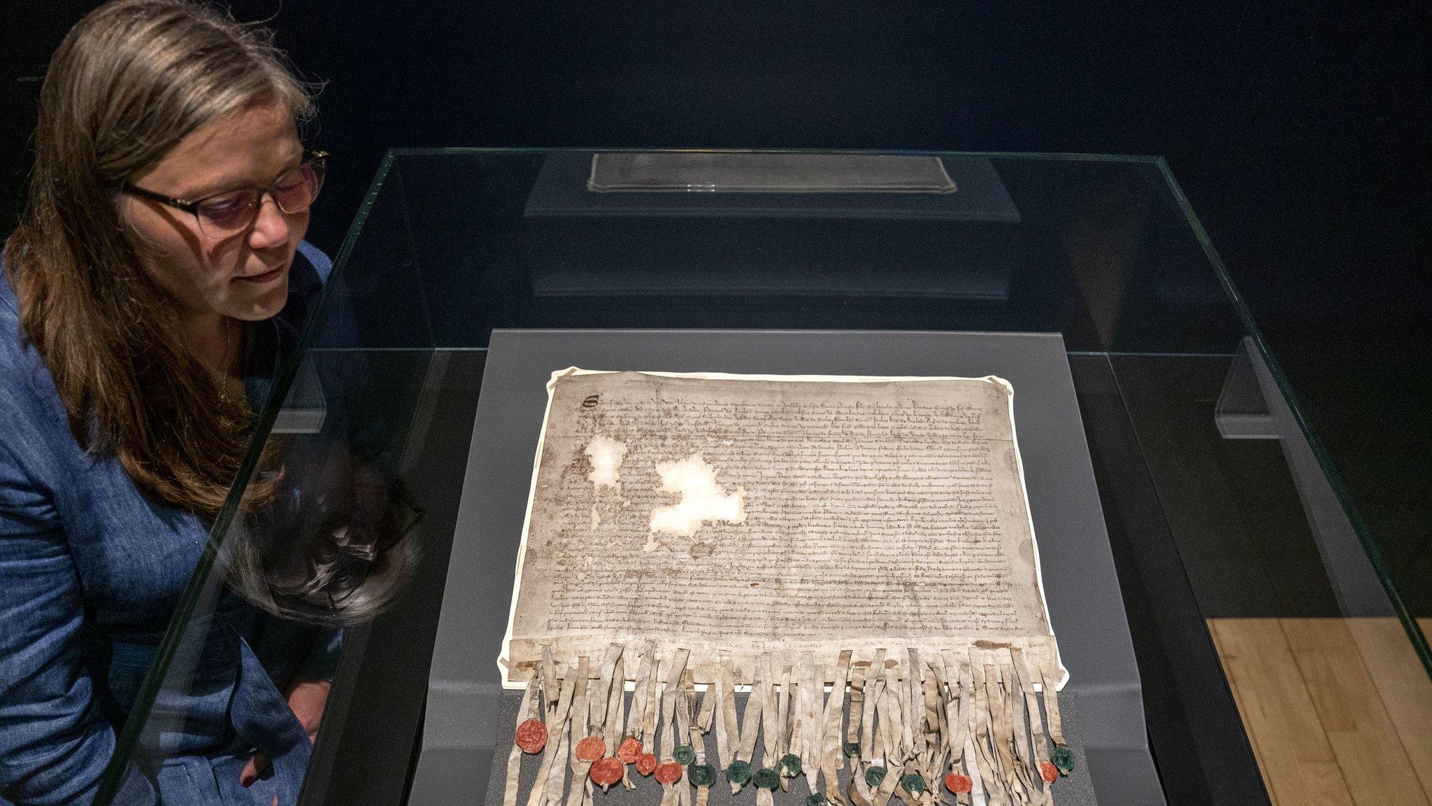 Woman standing next to Declaration of Arbroath