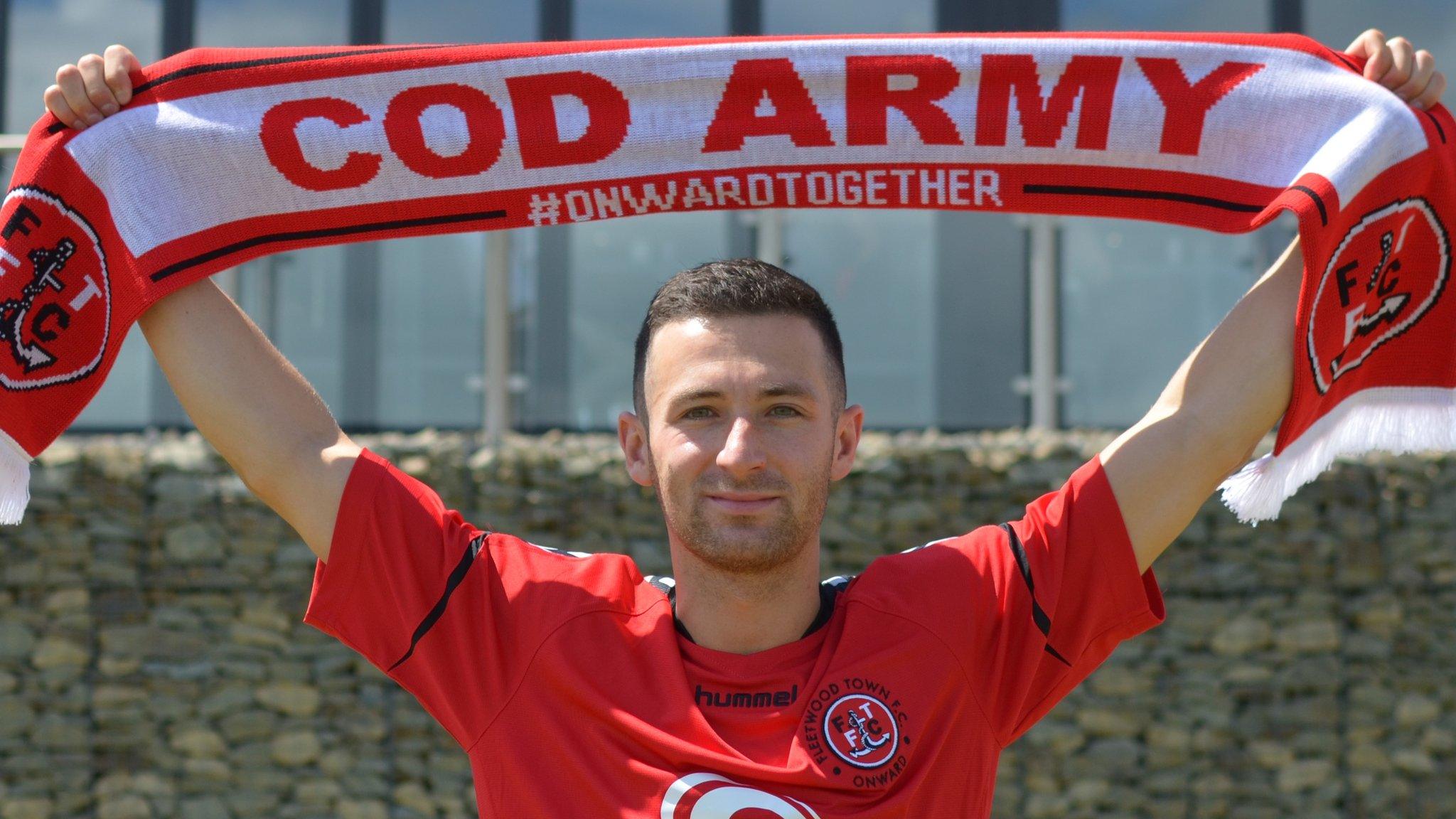 Jason Holt holding a Fleetwood scarf