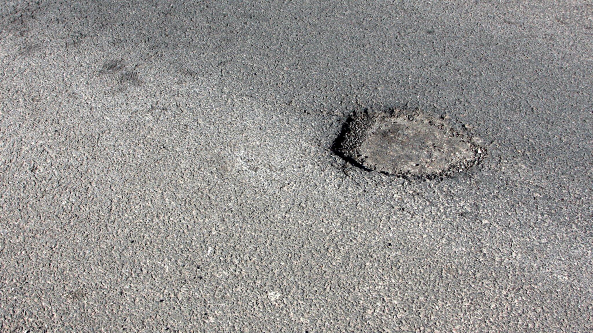 Potholes in road