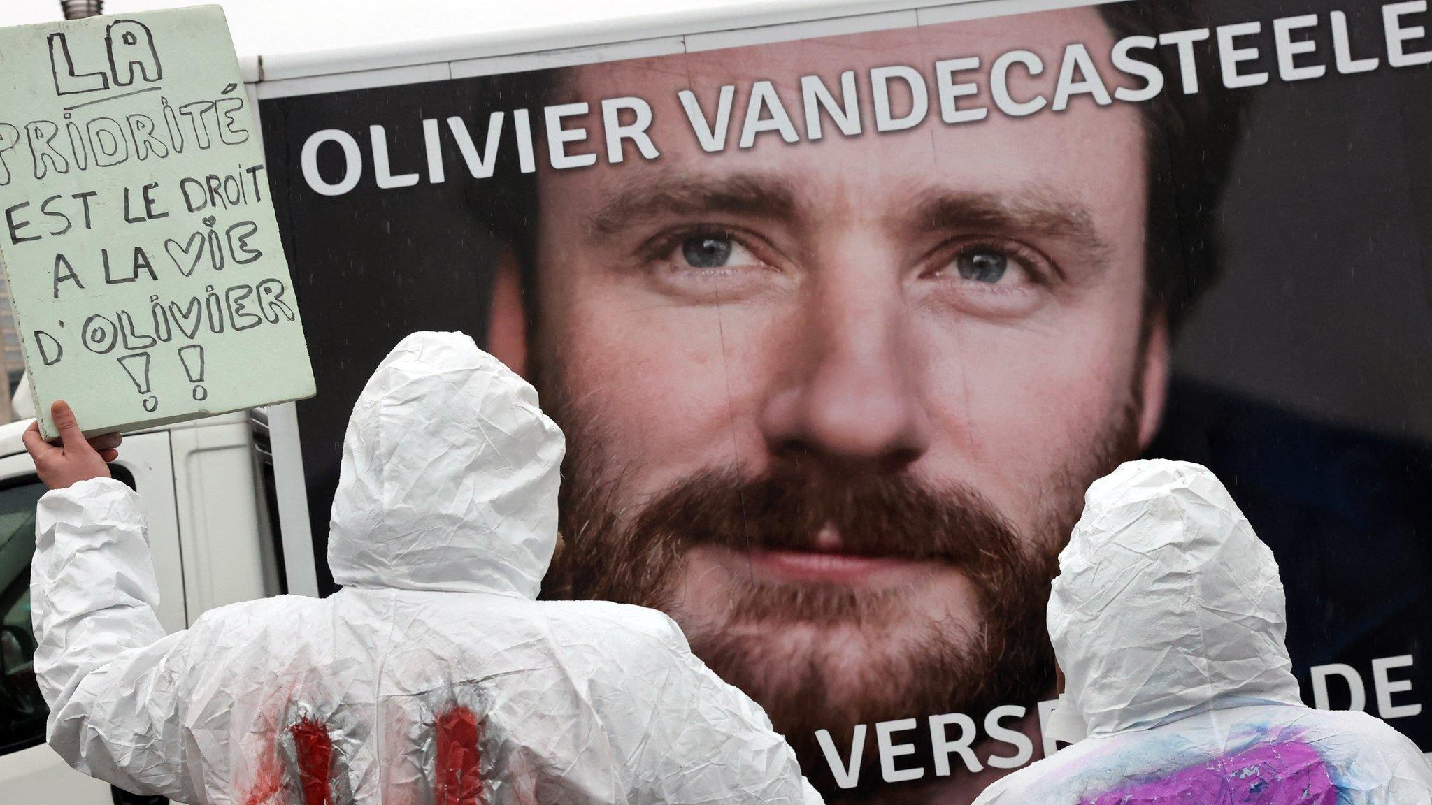 Protesters hold a placard reading "The priority is the right of living for Olivier" during a rally in solidarity with Olivier Vandecasteele in Brussels, Belgium, on 25 December 2022