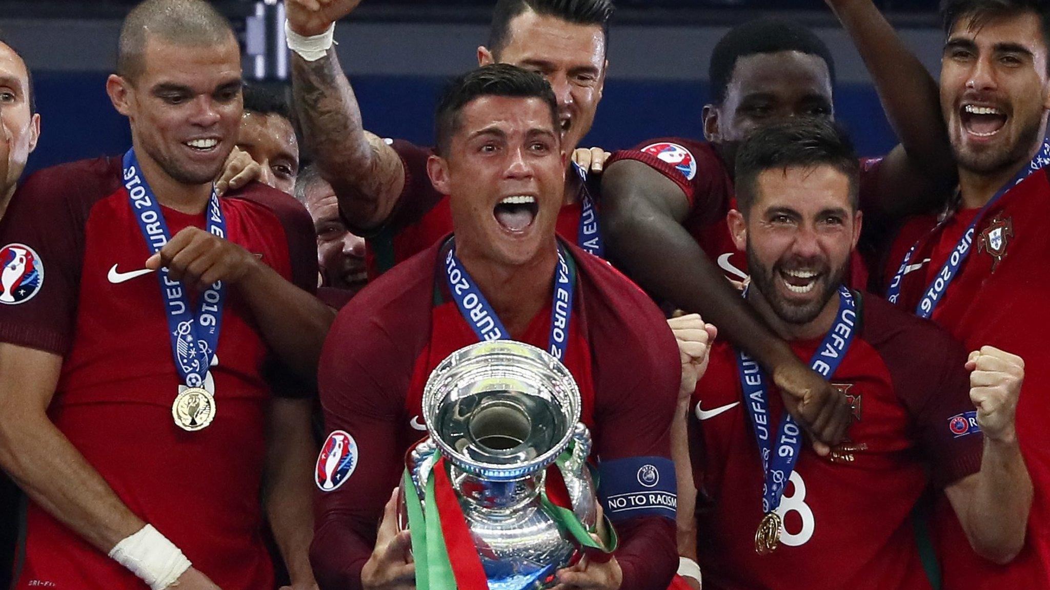 Cristiano Ronaldo celebrates with the trophy