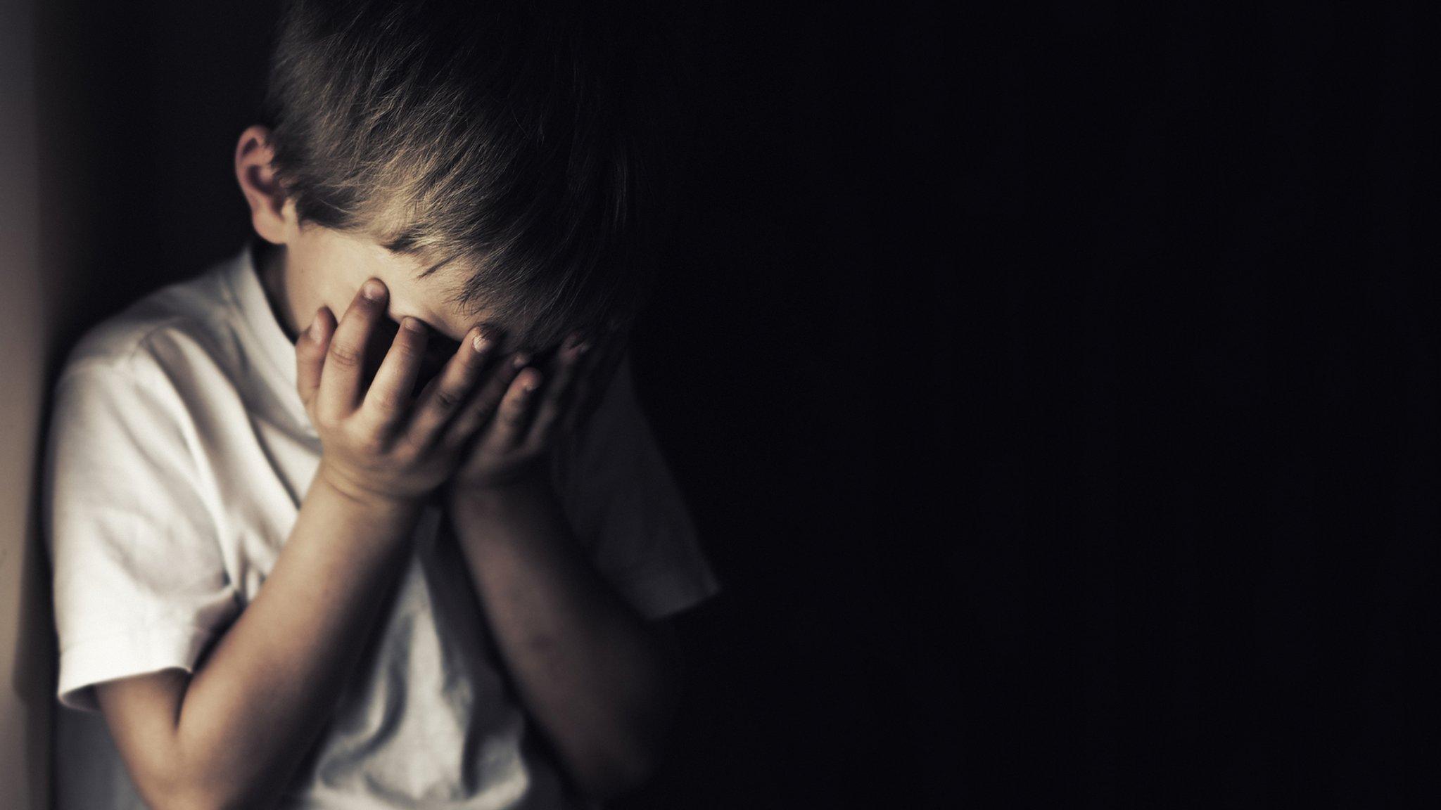 Child covering his face