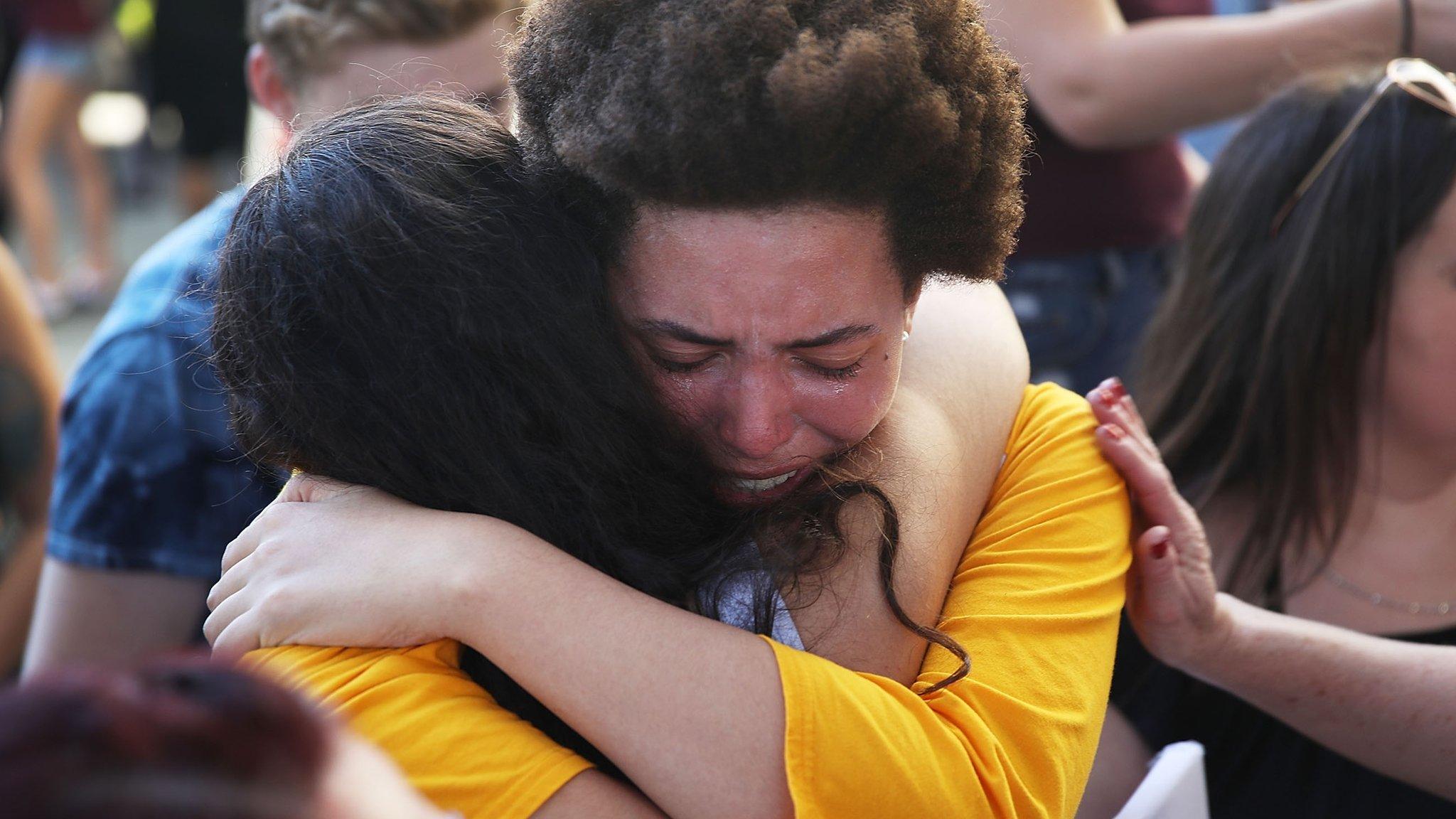 Ellie Branson is comforted as she joins with others after a school shooting that killed 17 to protest against guns on the steps of the Broward County Federal courthouse on February 17, 2018 in Fort Lauderdale, Florida