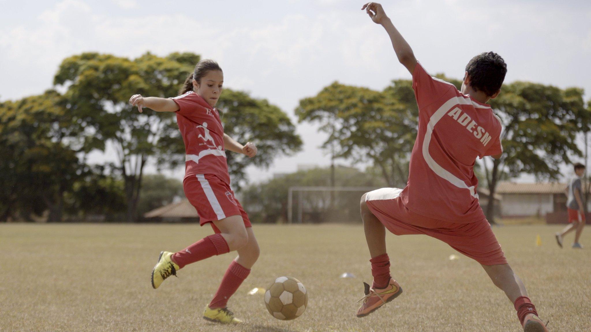 Laura Pigatin playing football with her team members