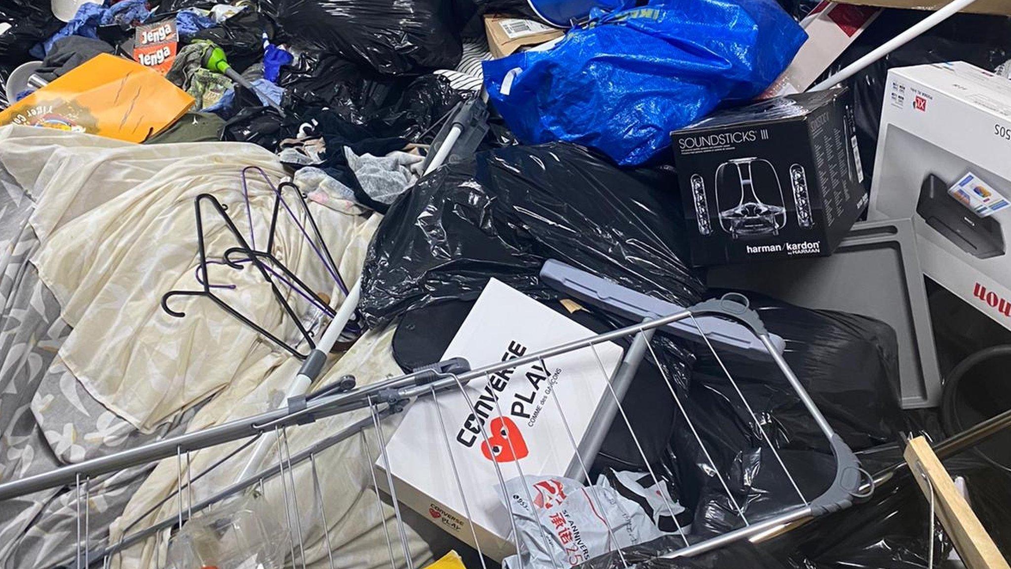 Piles of students possessions thrown into the bin stores.