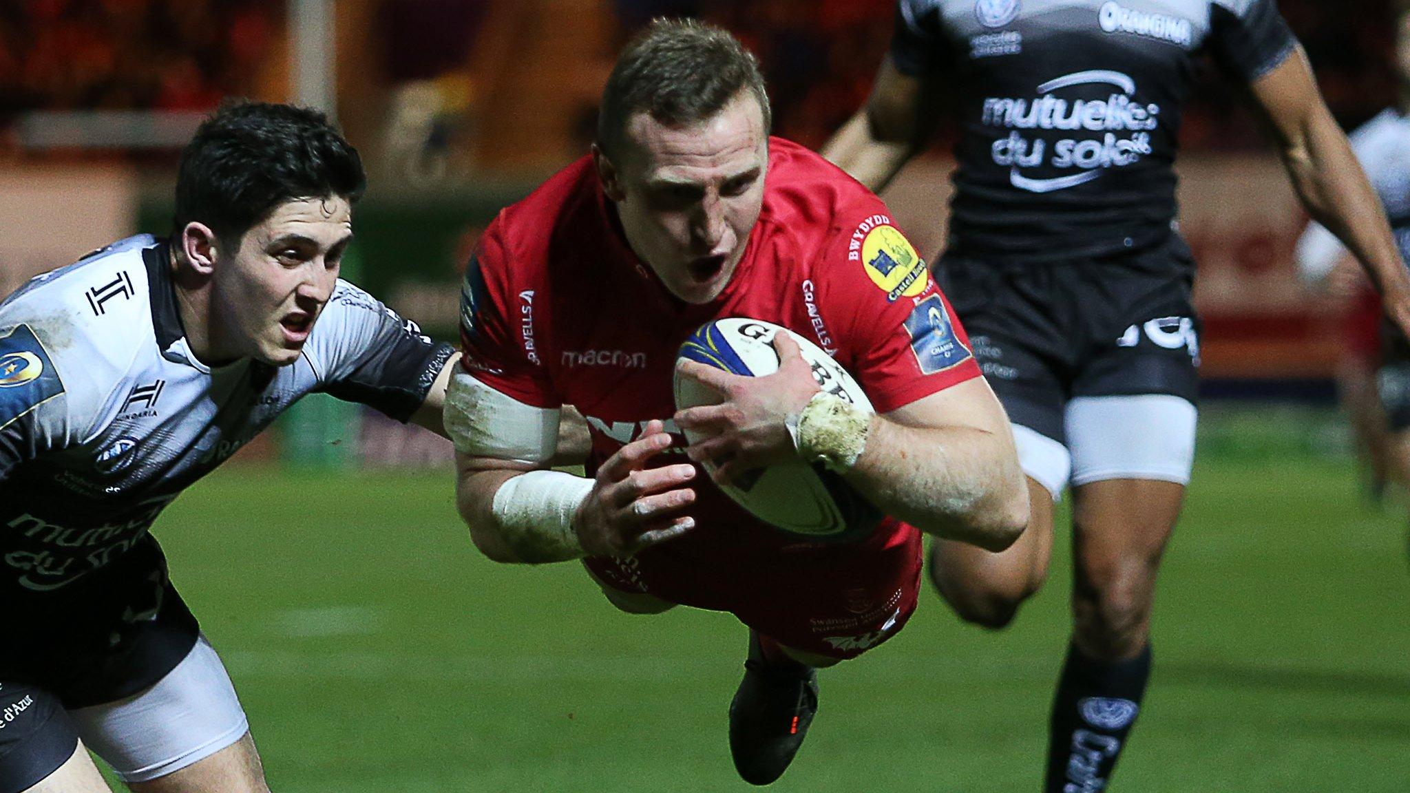 Hadleigh Parkes is airborne as he scores for Scarlets