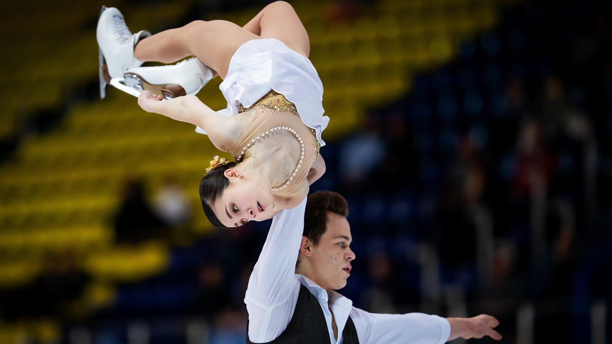 Apollinariia Panfilova and Dmitry Rylov of Russia perform a daring lift in the junior pairs free skating event at the World Junior Figure Skating Championships.
