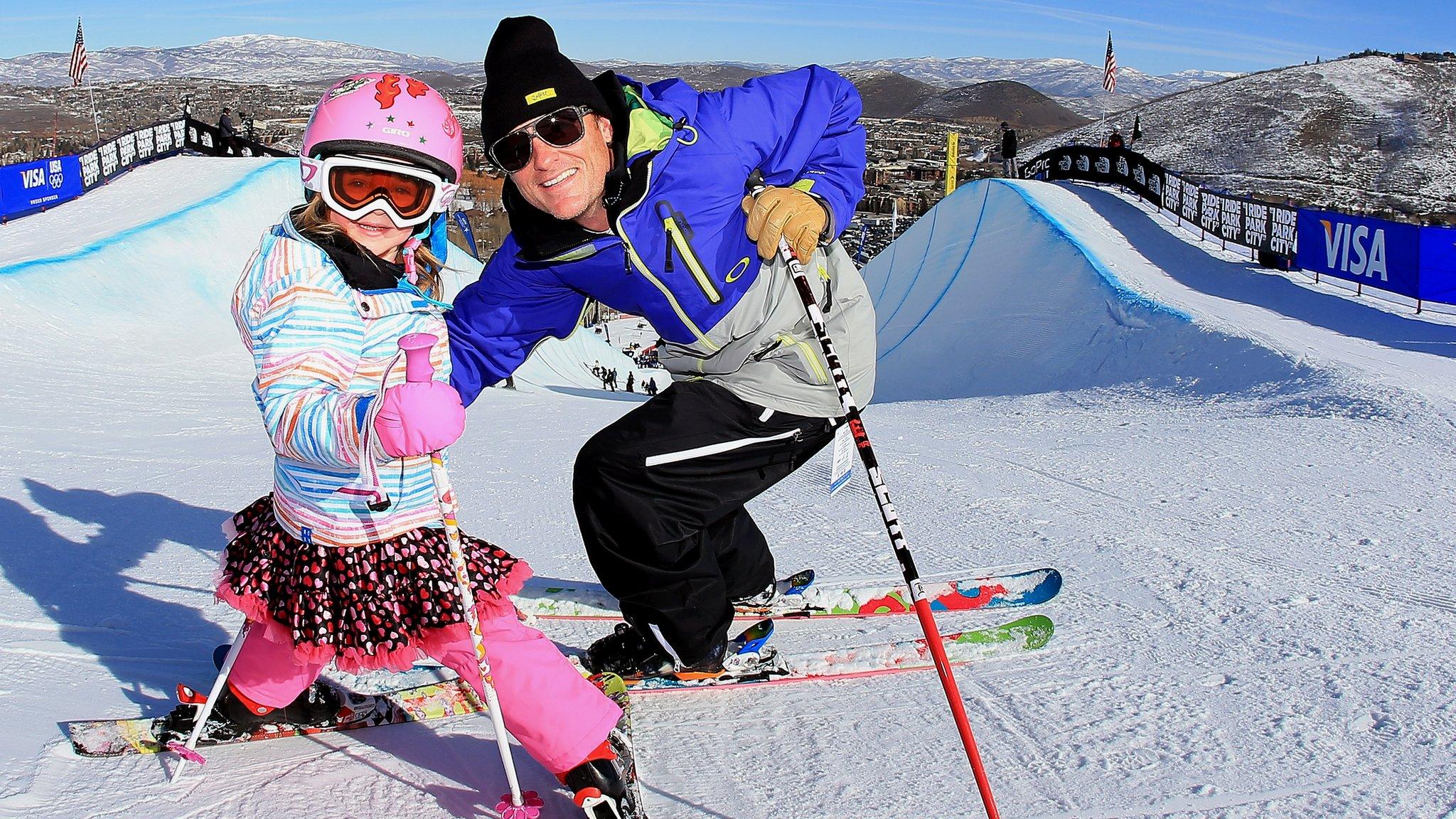 Dad and daughter skiing