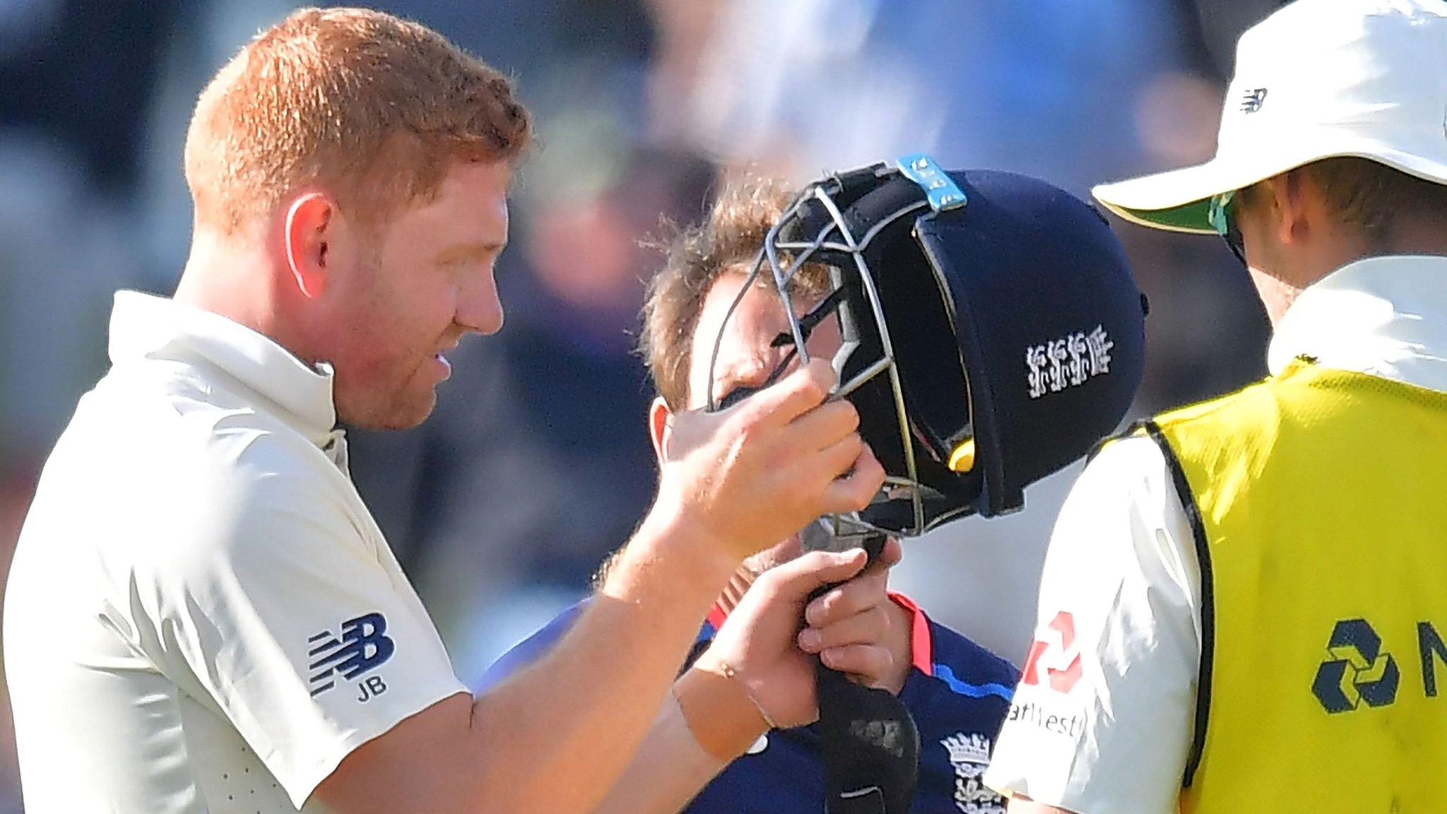 Jonny Bairstow inspects his helmet