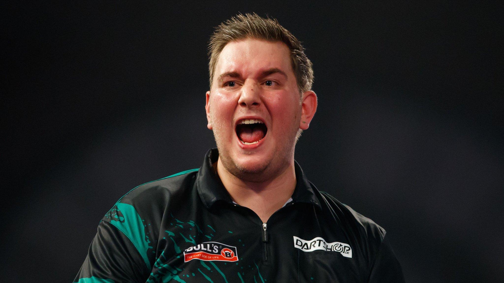 Kevin Munch celebrates beating Adrian Lewis in round one of the PDC World Darts