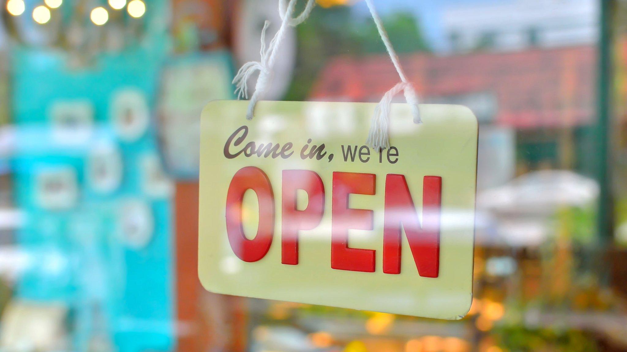 Shop open sign hanging on a door