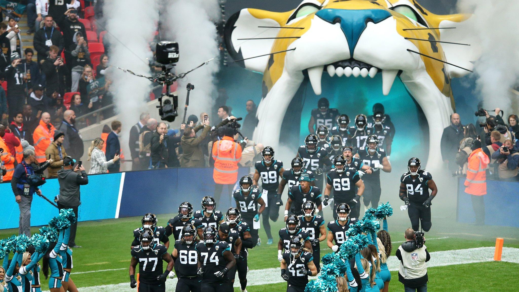 The Jacksonville Jaguars run out from a tunnel of the Jaguar logo at Wembley Stadium