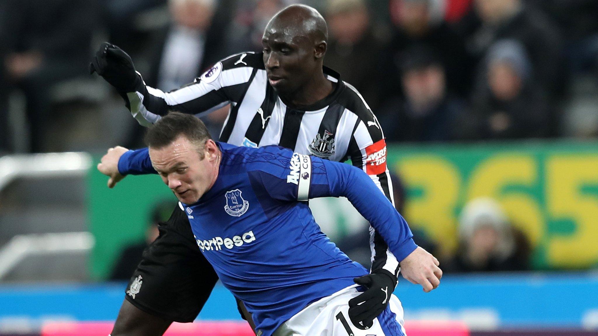 Wayne Rooney and Mohamed Diame challenge for the ball