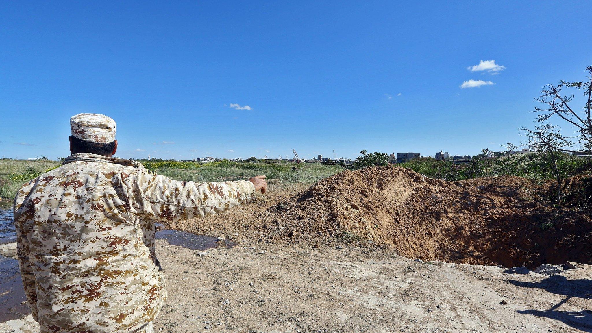 A crater is seen near the blast site after the air strike