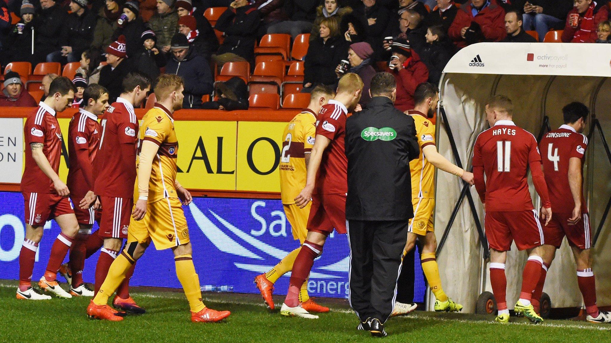 Aberdeen and Motherwell players trudge off after six minutes