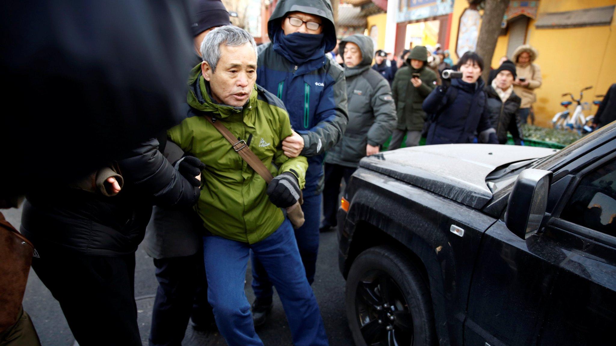 A supporter of prominent rights lawyer Wang Quanzhang is detained outside the courthouse where his trial is held, in Tianjin, China December 26, 2018.