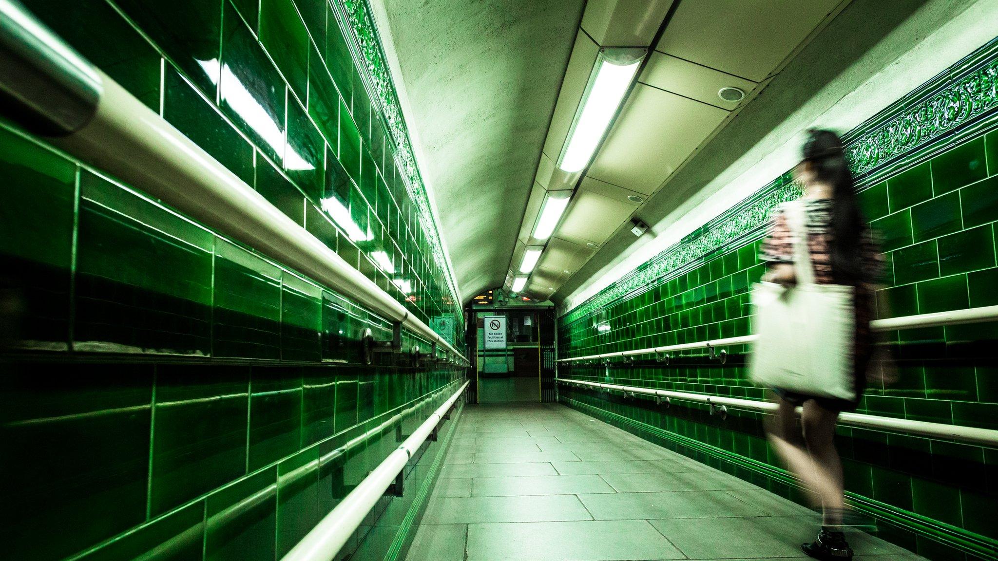 Blurred image of a woman in a deserted subway