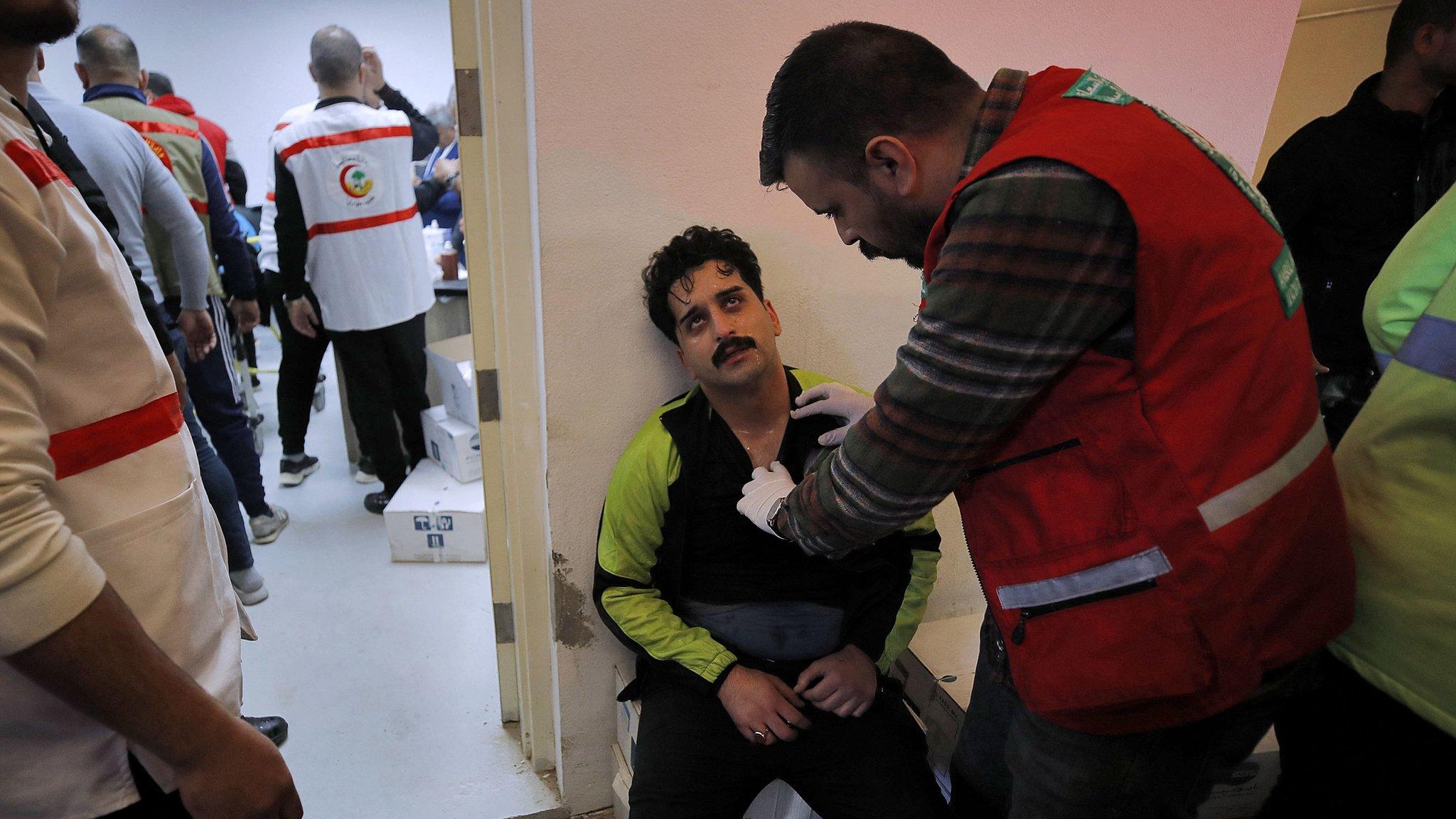 An injured football fan receives treatment after a crush outside the Basra International Stadium in Basra, Iraq (19 January 2023)