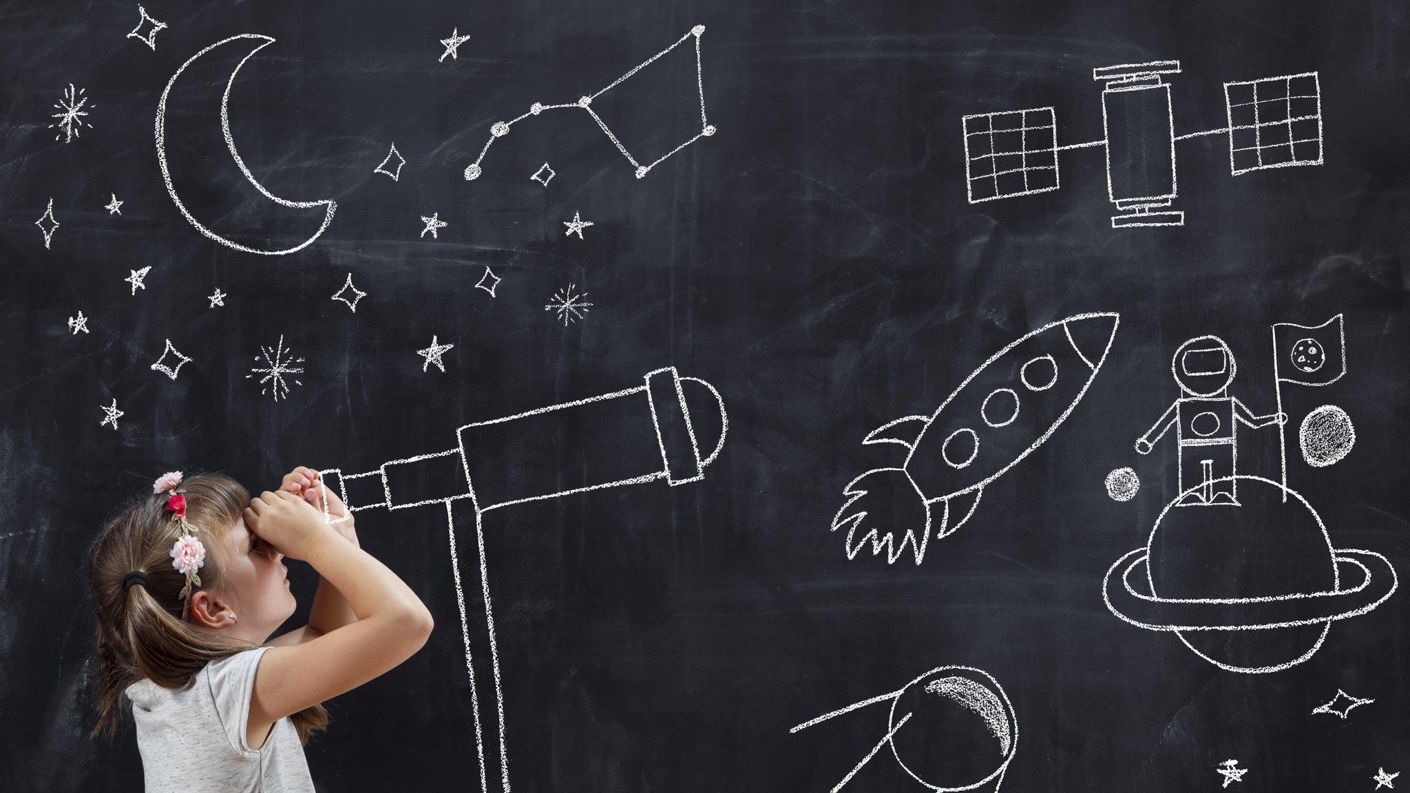 girl-looks-through-telescope-drawn-on-blackboard-a -images-of-space