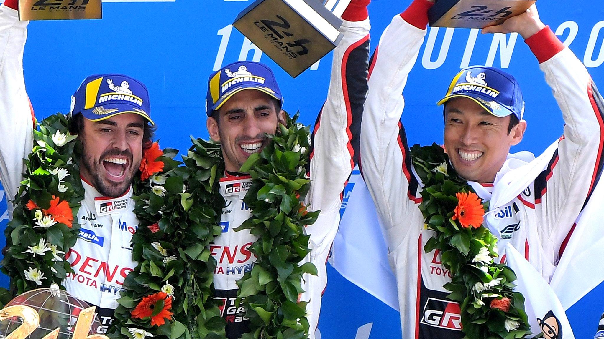 Toyota TS050 Hybrid LMP1's drivers Fernando Alonso of Spain (L), Kazuki Nakajima of Japan (R) and Sebastien Buemi of Switzerland (C), celebrate on the podium after winning