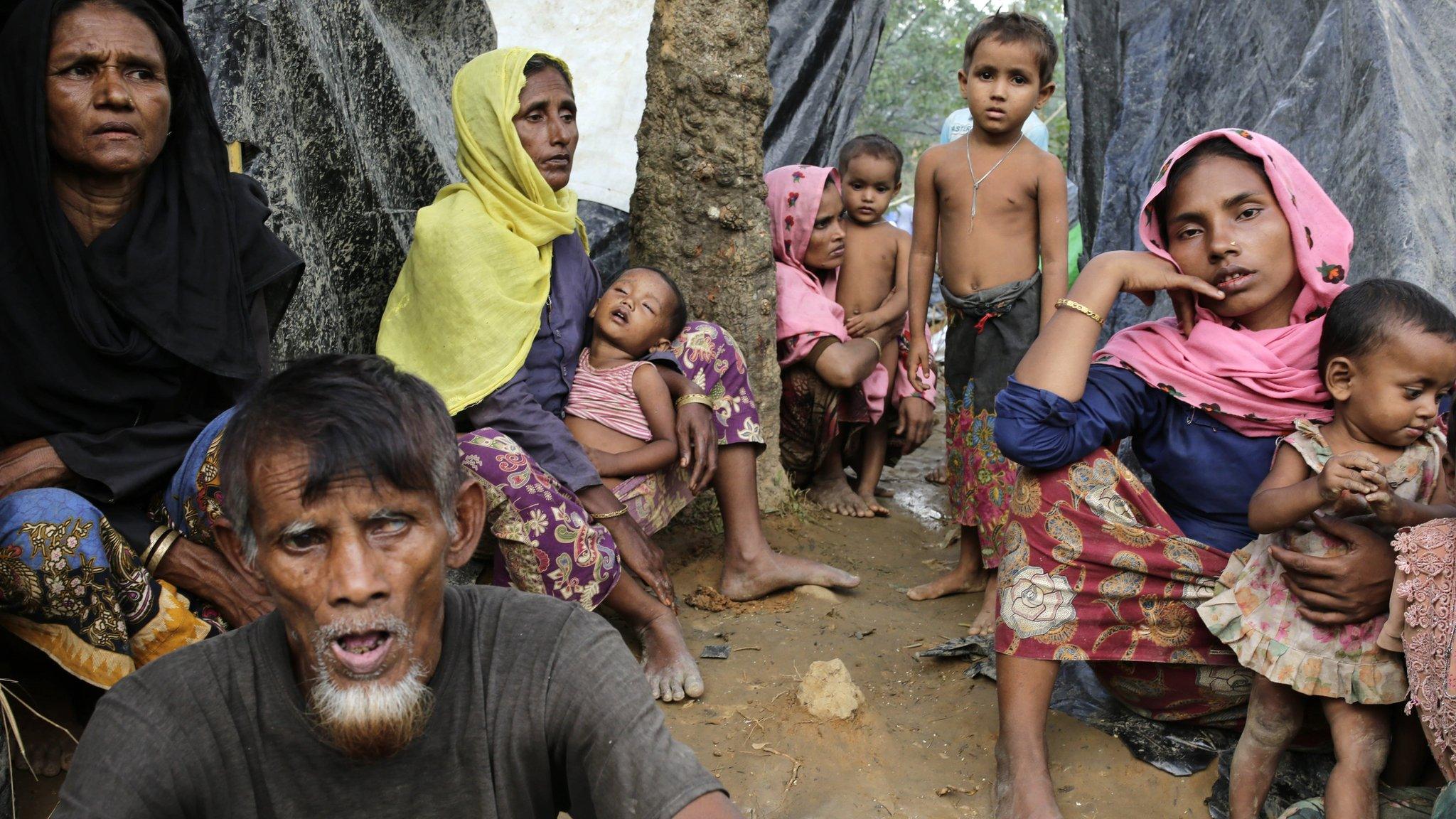 Rohingya women sit in front of their makeshift shelters in a camp in Ukhiya, Cox's Bazar, Bangladesh, 11 September 2017