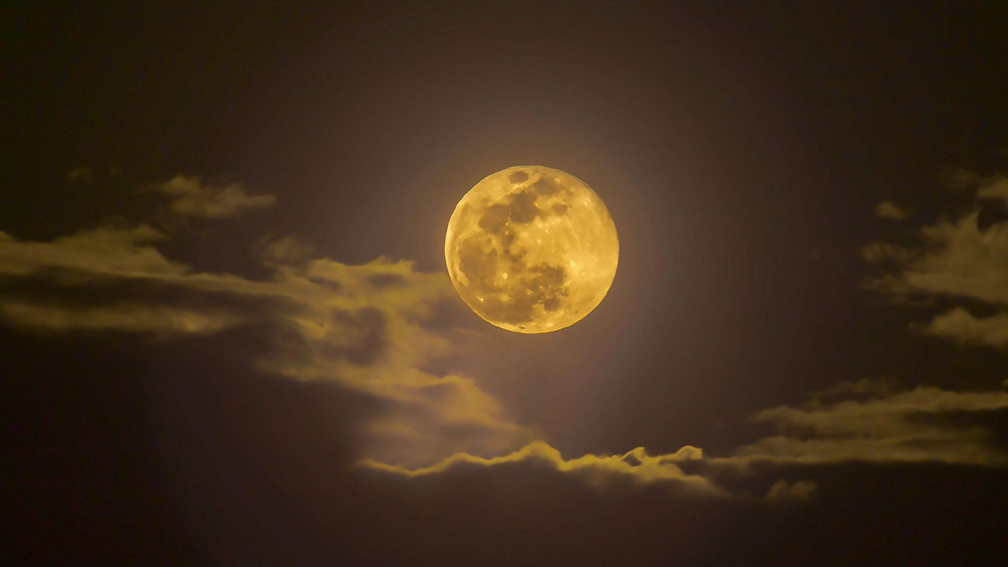 Snow Moon in 2019 coming through the clouds.