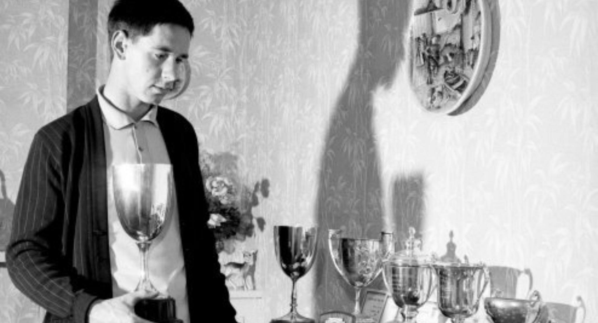 Colin Lewis with trophies at his home