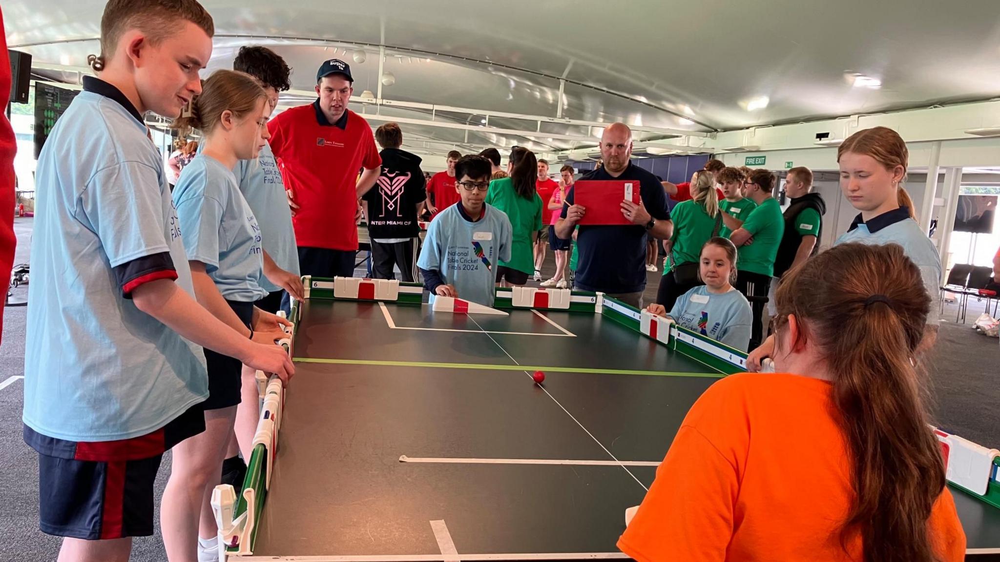 Children playing table cricket