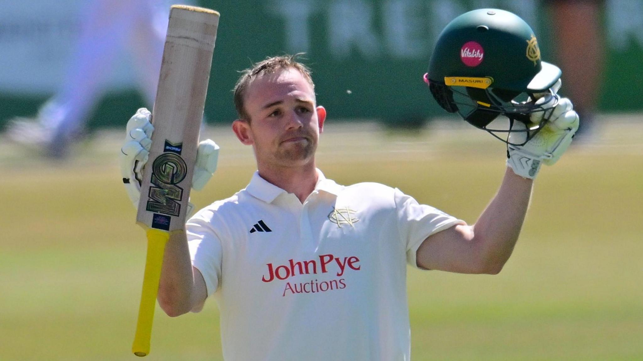 Jack Haynes raises his bat and helmet