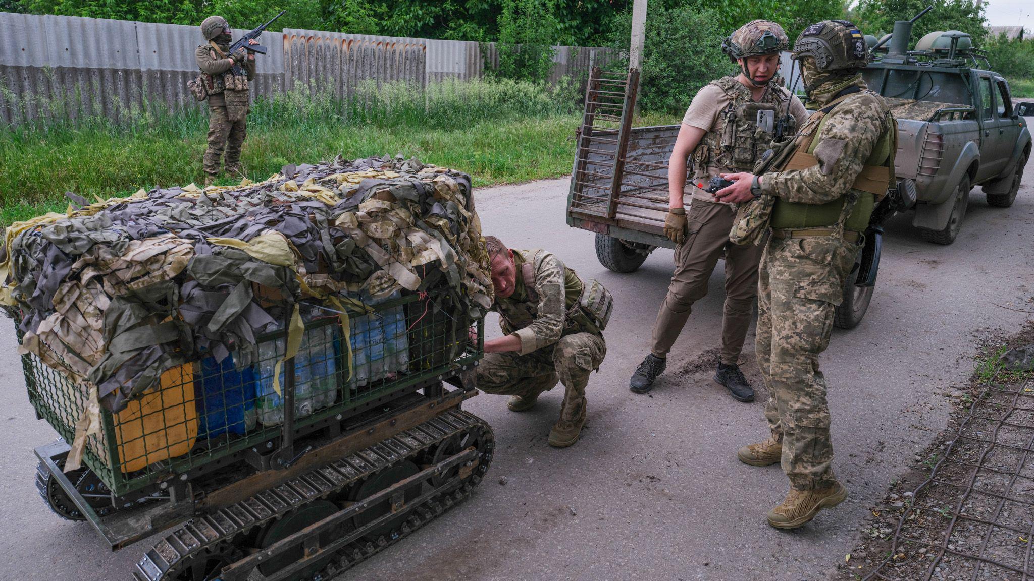 A robot laden with supplies arrives near the front line
