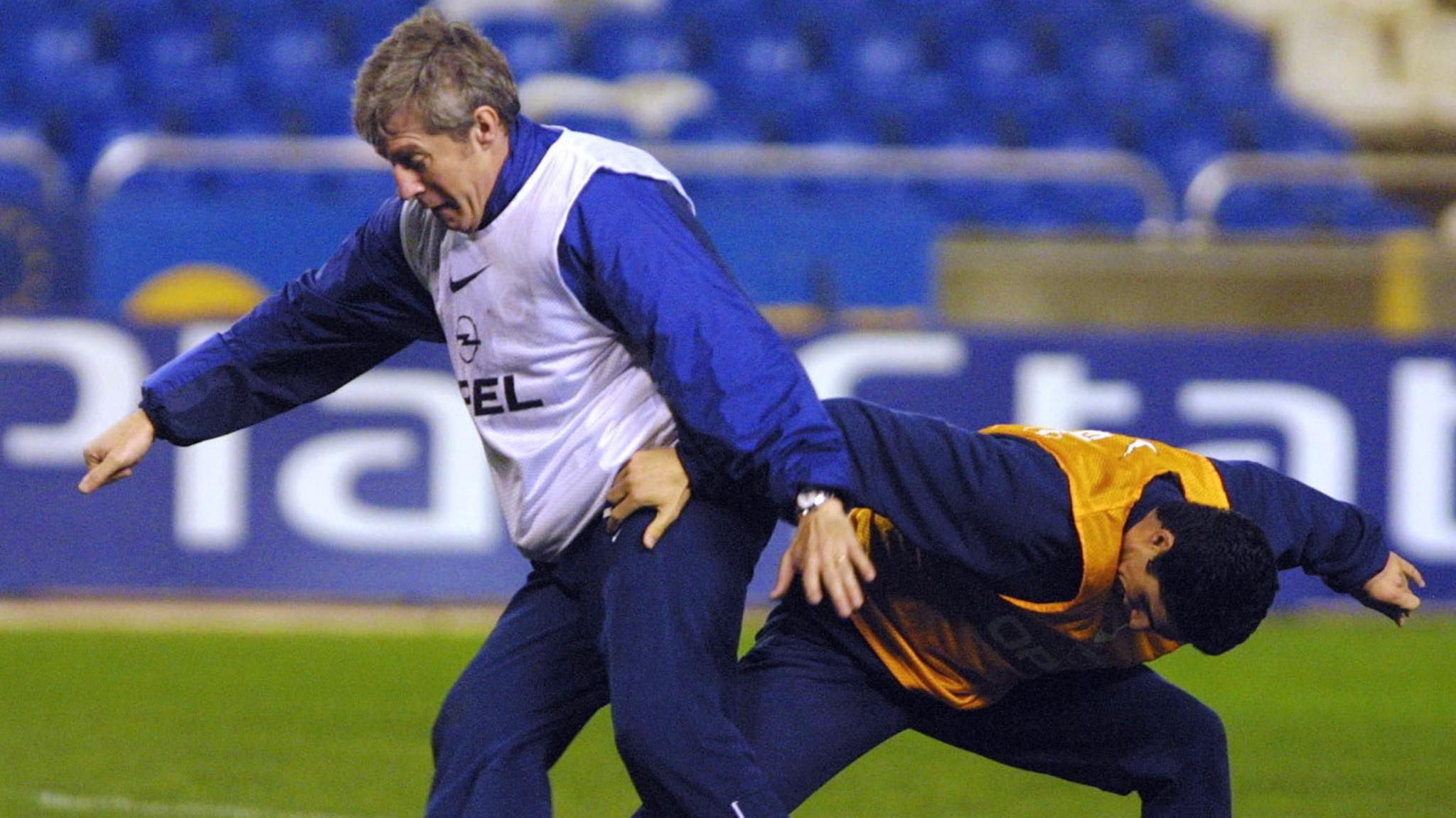 Paris St-Germain manager Luis Fernandez shields the ball from Mikel Arteta during a training session