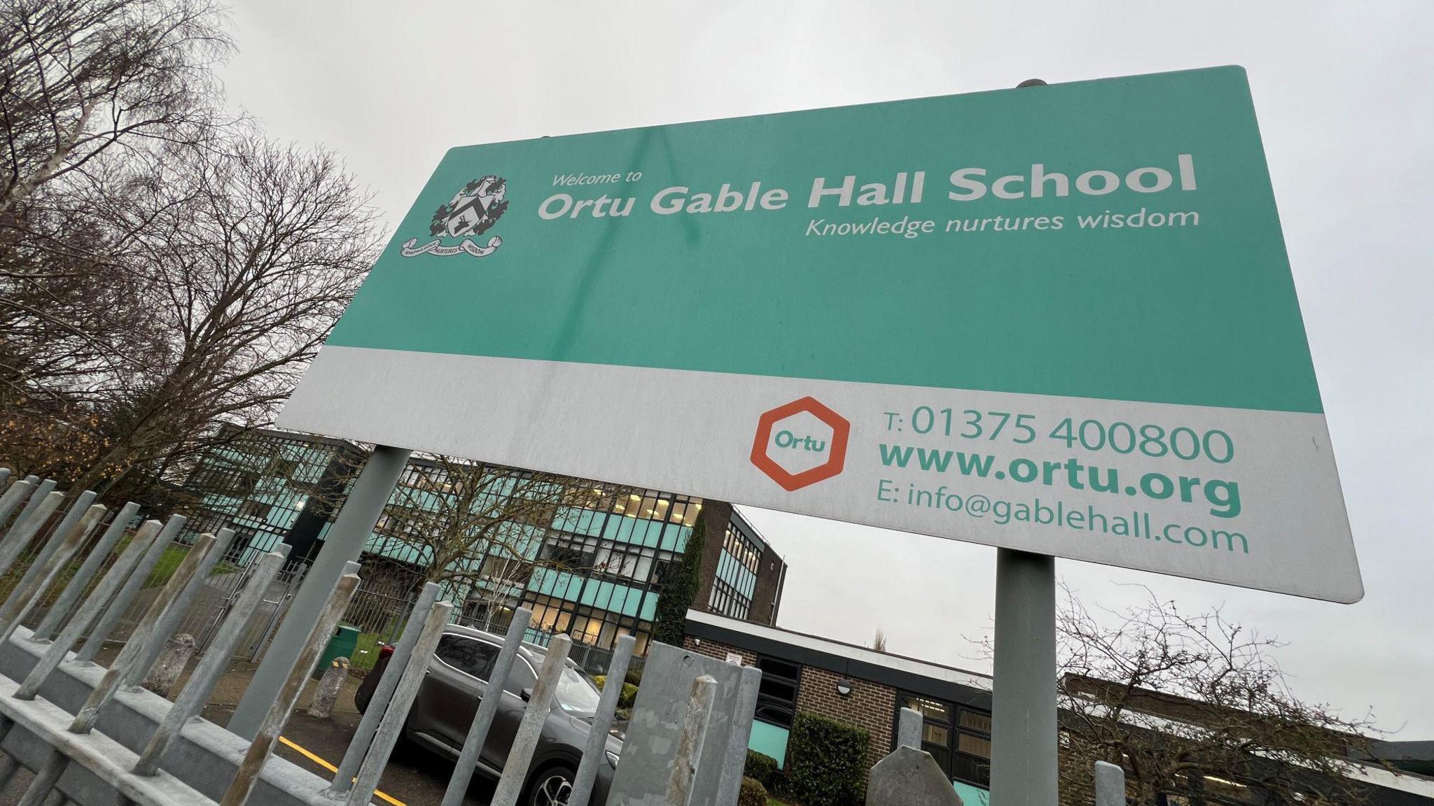 School sign detailing name of school.