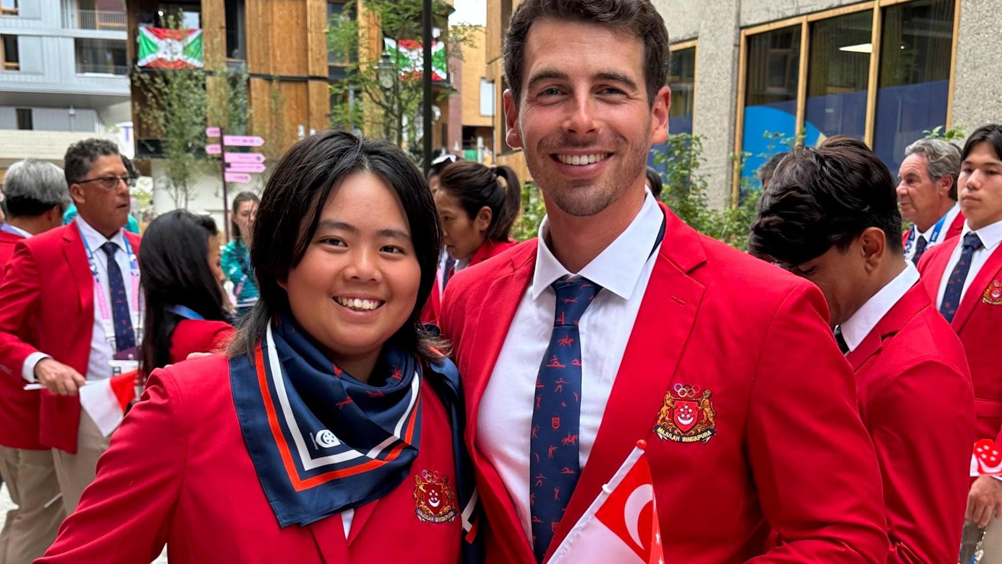 Robin and Shannon experience the Olympic spirit, wearing their Singaporean kit.