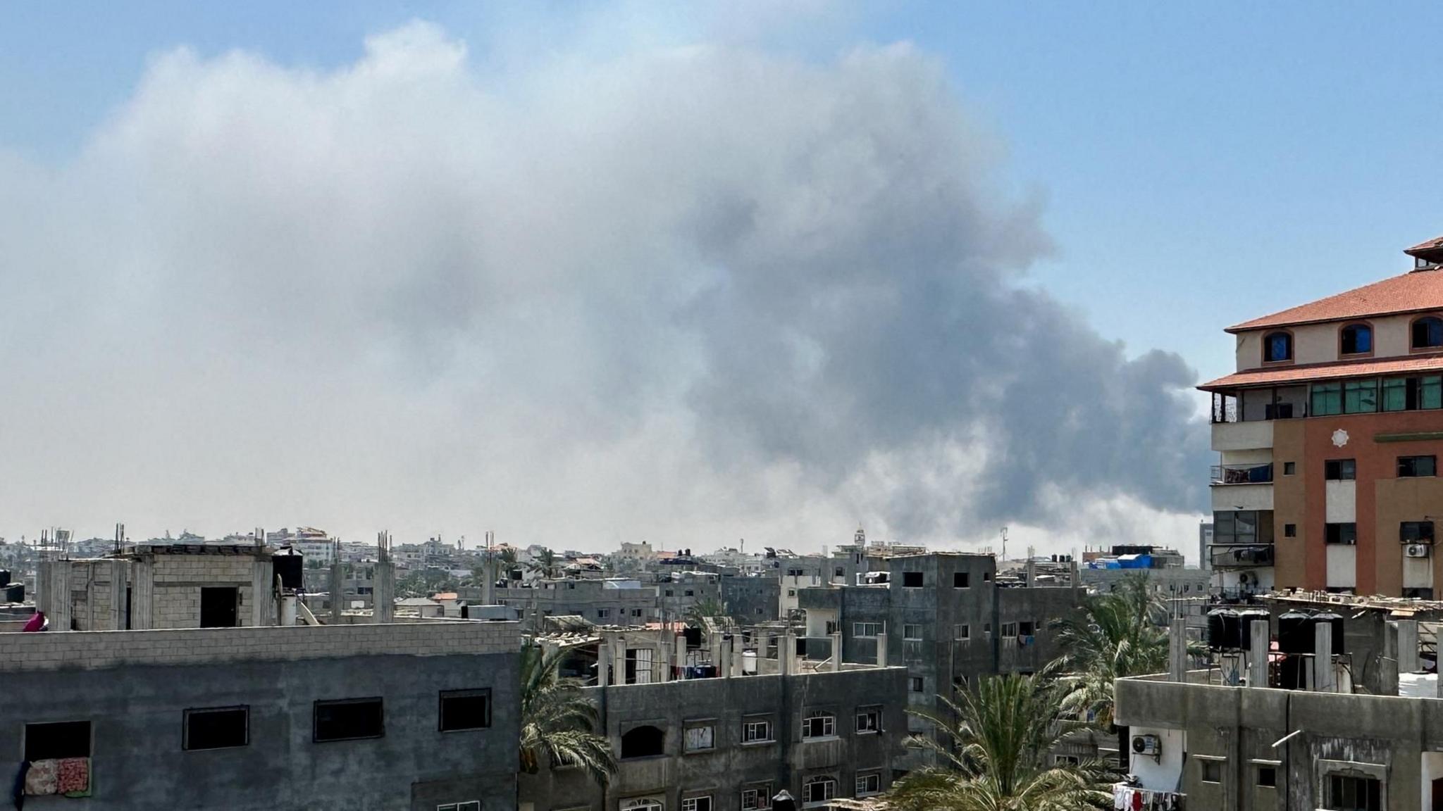 Smoke rises following Israeli strikes in the Deir al-Balah area, in central Gaza, 21 July 2025