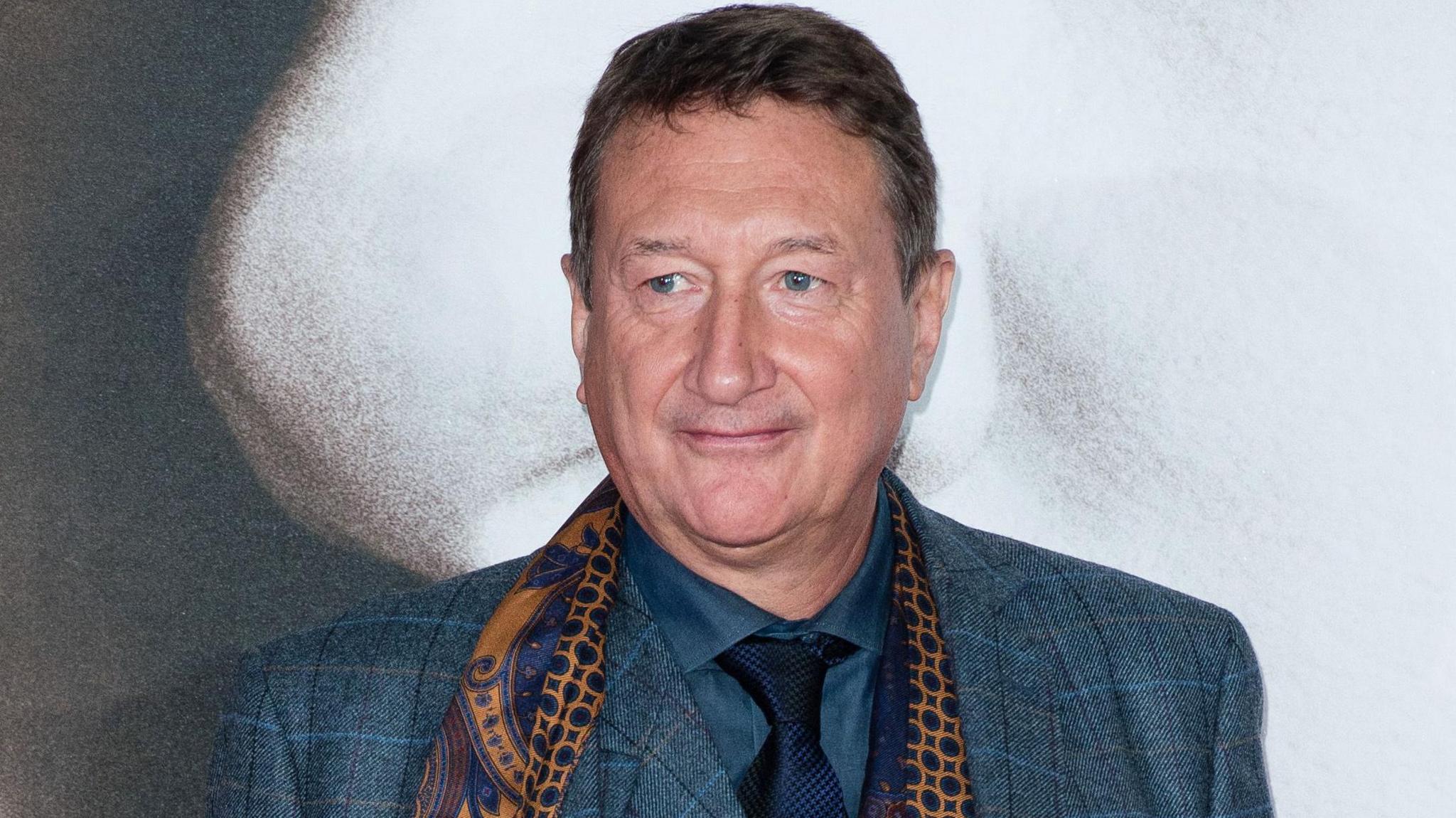 Steven Knight in a smart suit and scarf