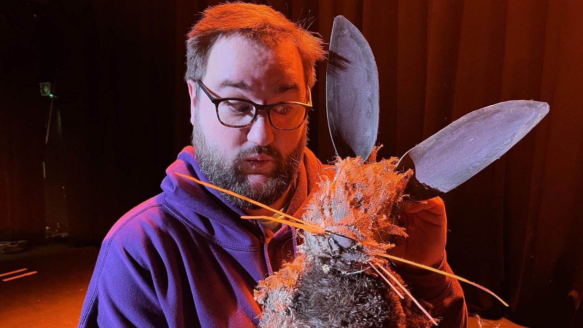 Jason Lower holding a puppet rabbit