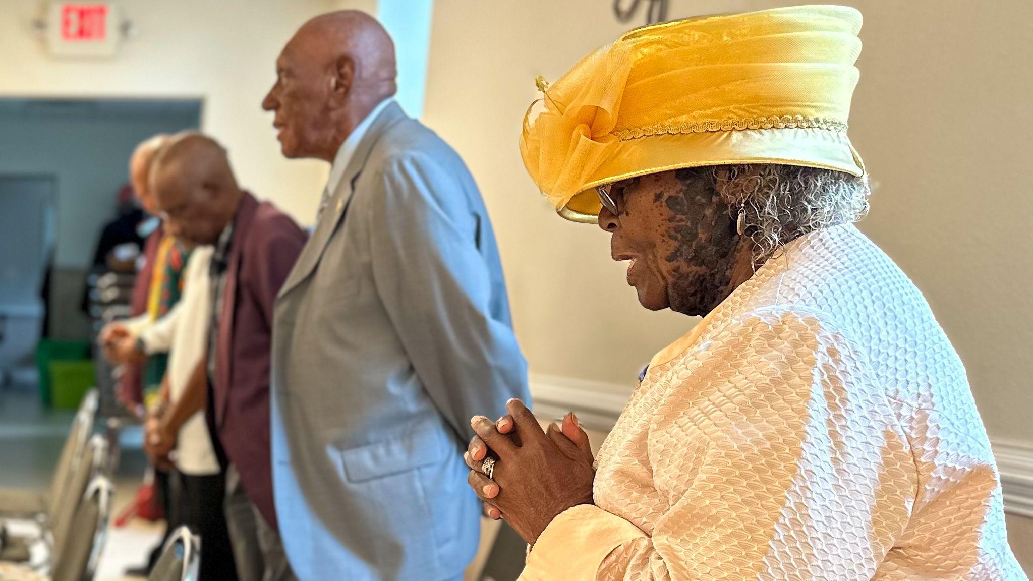 A woman praying inside Mt Lebanon AME Zion Church in Elizabeth City, North Carolina