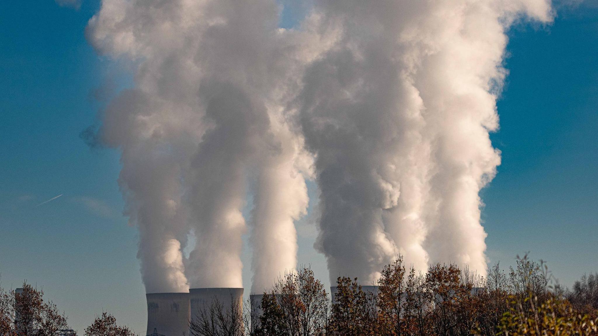 A power station pumps smoke into the sky