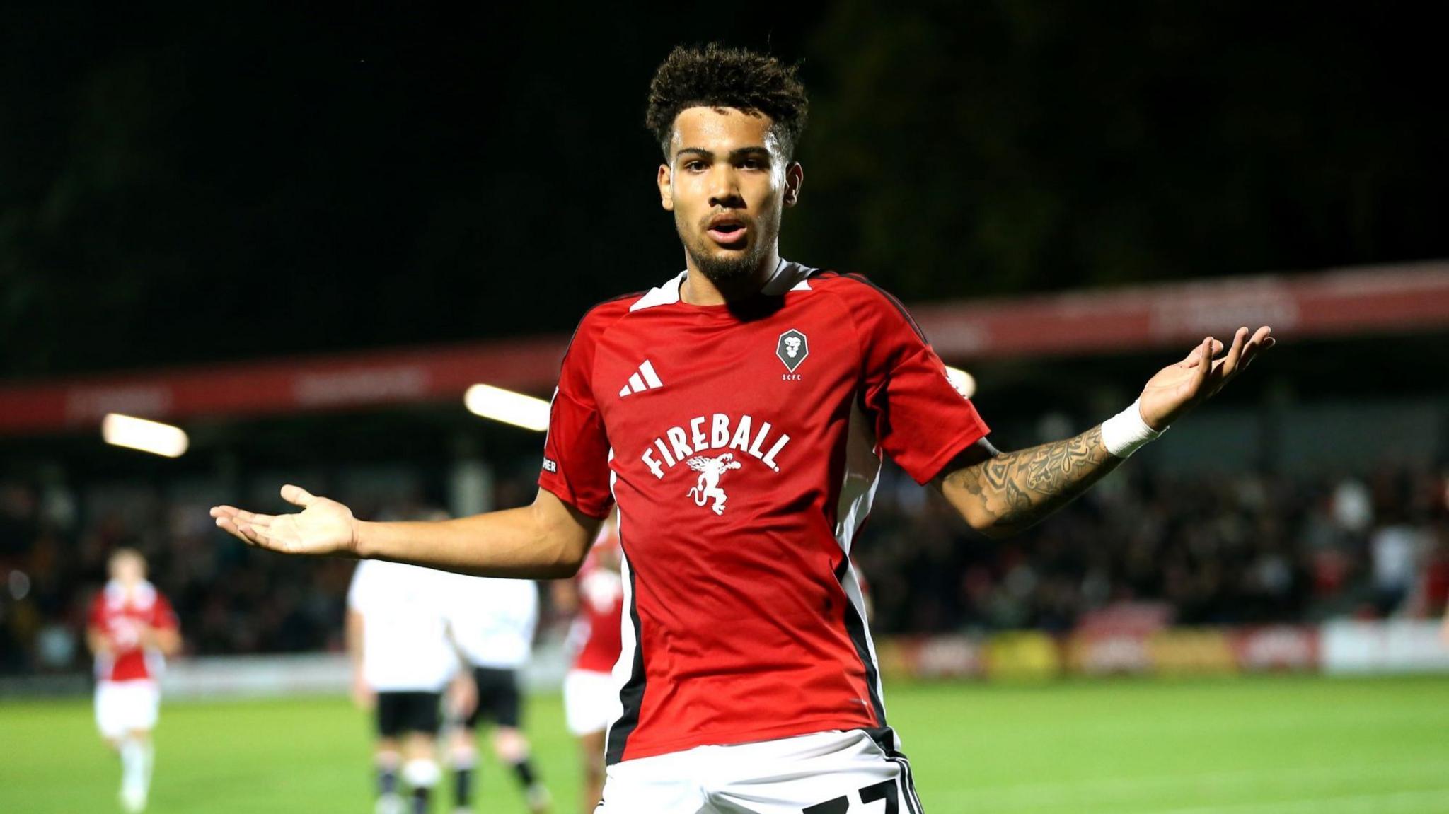 Frankie Okoronkwo holds his arms out in celebration 