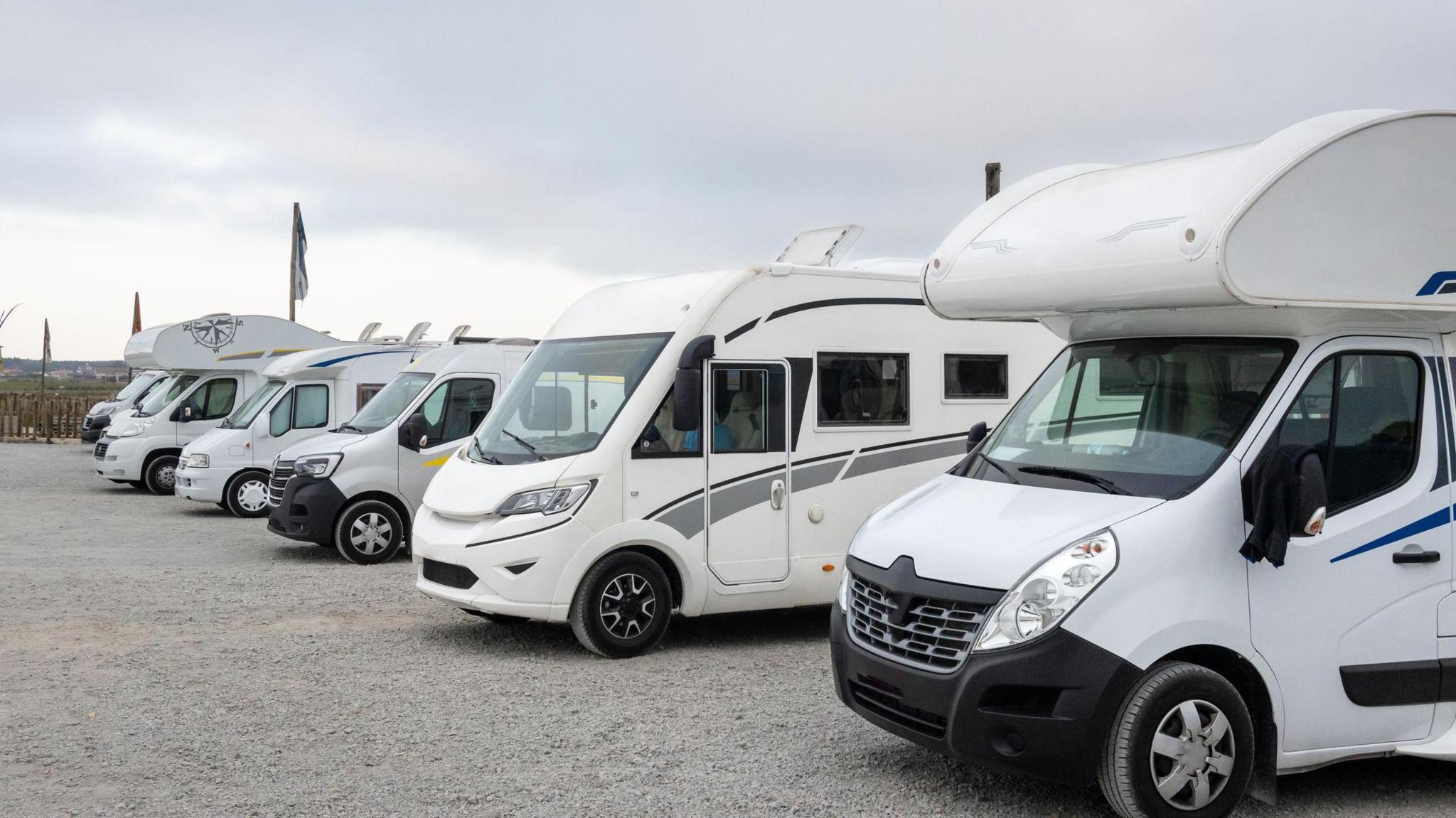 A row of five large leisure vehicles