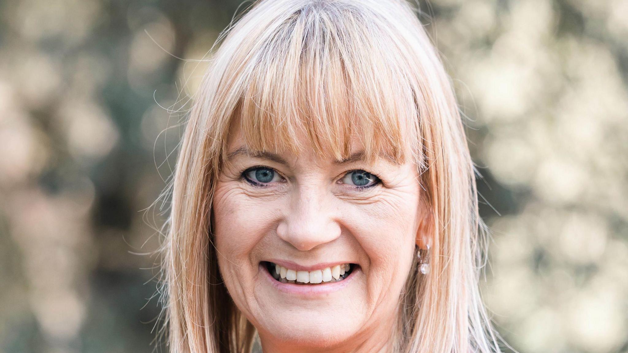 Prof Donna Fitzsimons smiling after learning she had become an Officer of the Order of the British Empire (OBE).