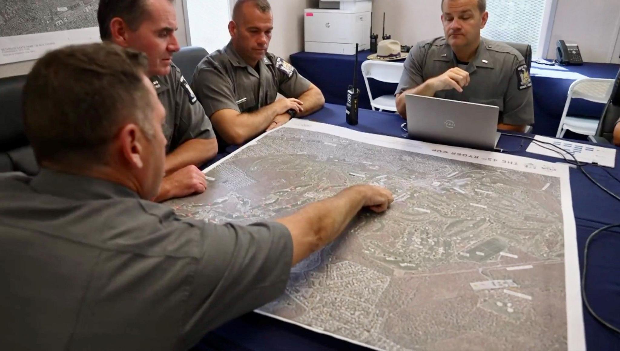 Law enforcement officials from New York State Police at their security command centre on the outskirts of Bethpage golf course