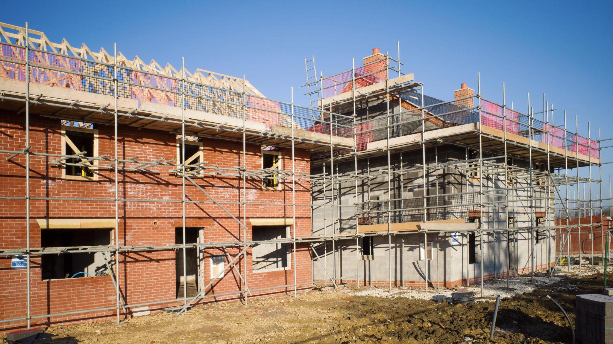 New build housing development with clear blue sky (stock photo)