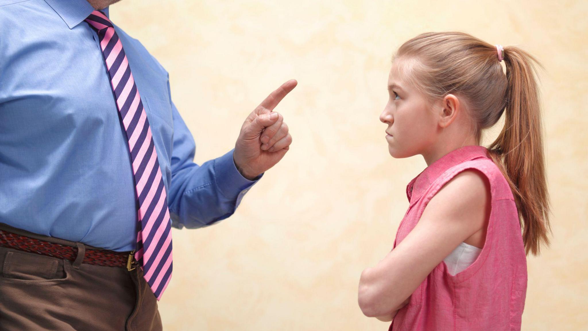 Child getting a warning from a teacher