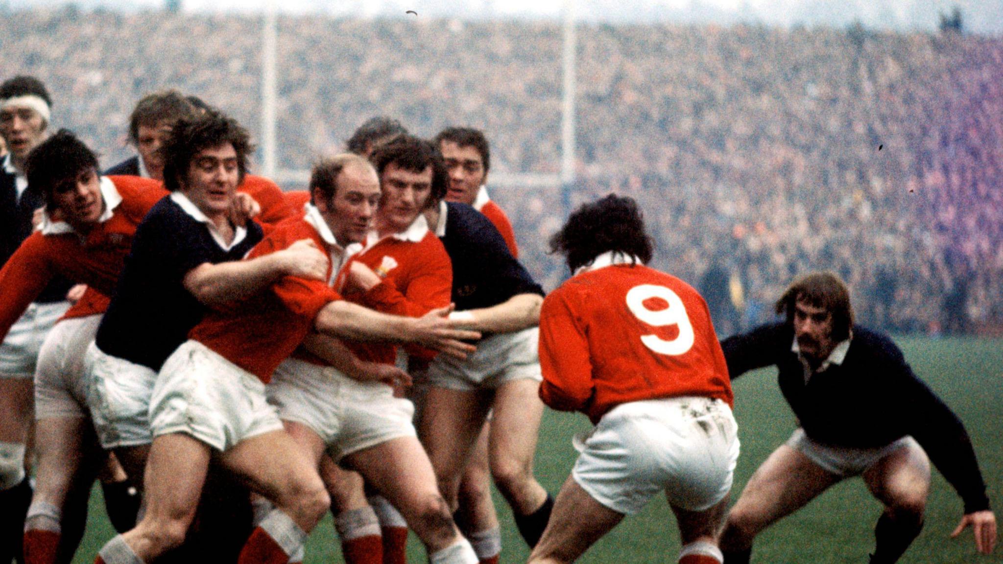 Scotland's Sandy Carmichael (3rd left) holds back the Welsh while David Leslie (far right) looks on
